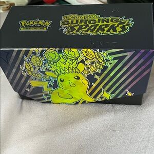 Pokemon Surging Sparks Collector Tin with Neon Yellow-Green Pikachu Artwork